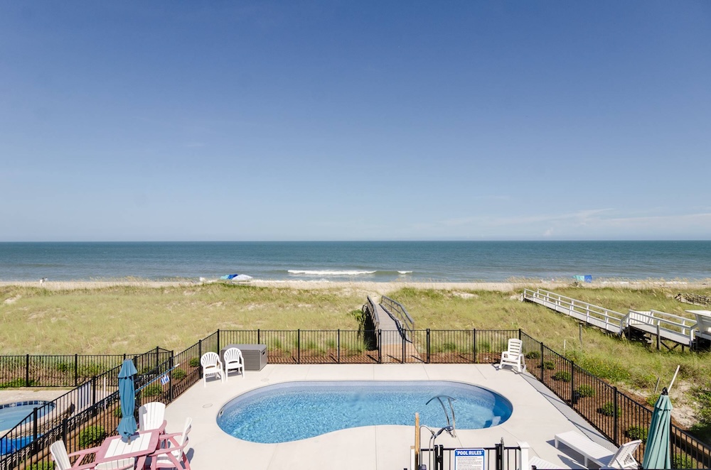 view of pool and ocean at a kure beach, nc vacation rental